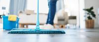 someone pushing a mop while cleaning a home